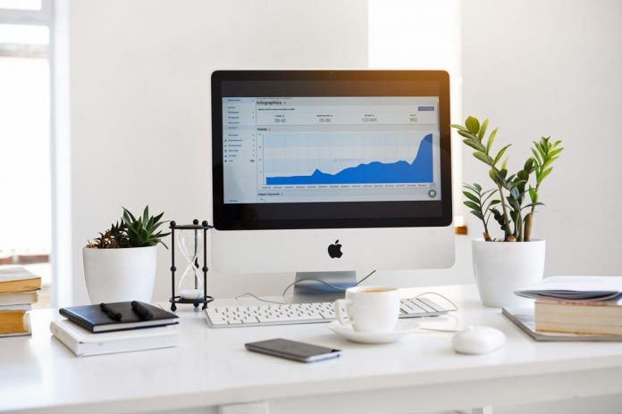 silver-imac-displaying-line-graph-placed-on-desk Silver Imac Displaying Line Graph Placed on Desk