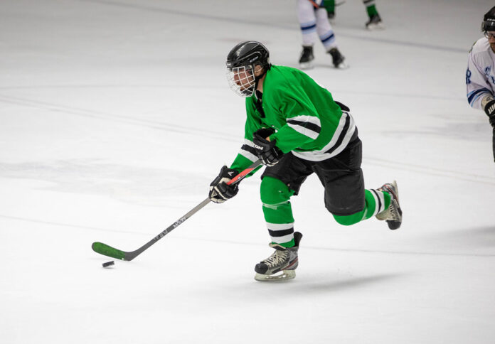 A hockey player on the ice Description automatically generated with medium confidence