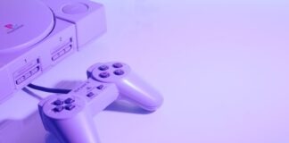 gray Sony PlayStation console with corded controller