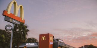 red and white concrete building near palm trees during daytime