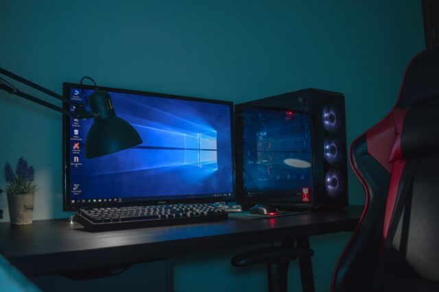 Photo by Balkouras Nicos turned on desktop computer set with black and gray leather gaming chair