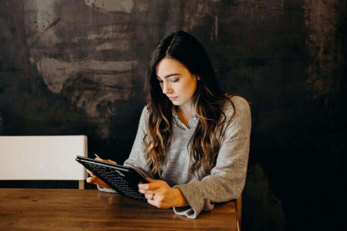 What Does MIP 67 Error Mean On Android? Plus, Here Is How To Fix It woman wearing white dress shirt using holding black leather case on brown wooden table