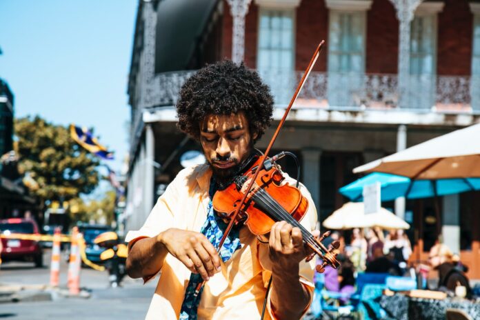 Celebrate Black History Month 2023 With Amazon A man playing the violin or fiddle on the streets in New Orleans in the French Quarter