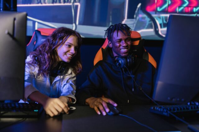 Photo by Alena Darmel Man and Woman Smiling While Playing Videogame