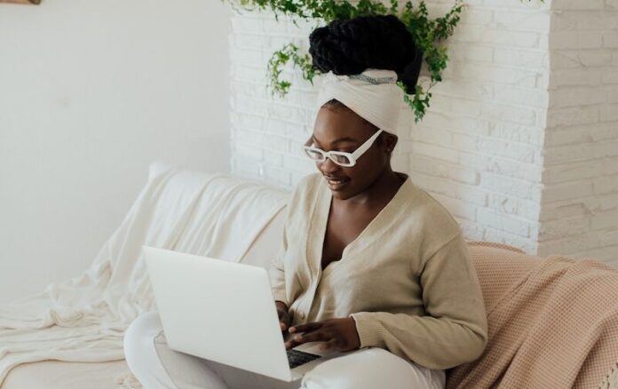 A Woman Using a Laptop on a Couch