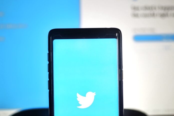 The Search Is Now On: Tired Of Twitter? Here Are Some Alternatives To Try - Twitter News black smartphone on blue surface