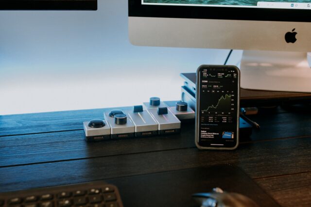 a remote control sitting next to a computer monitor