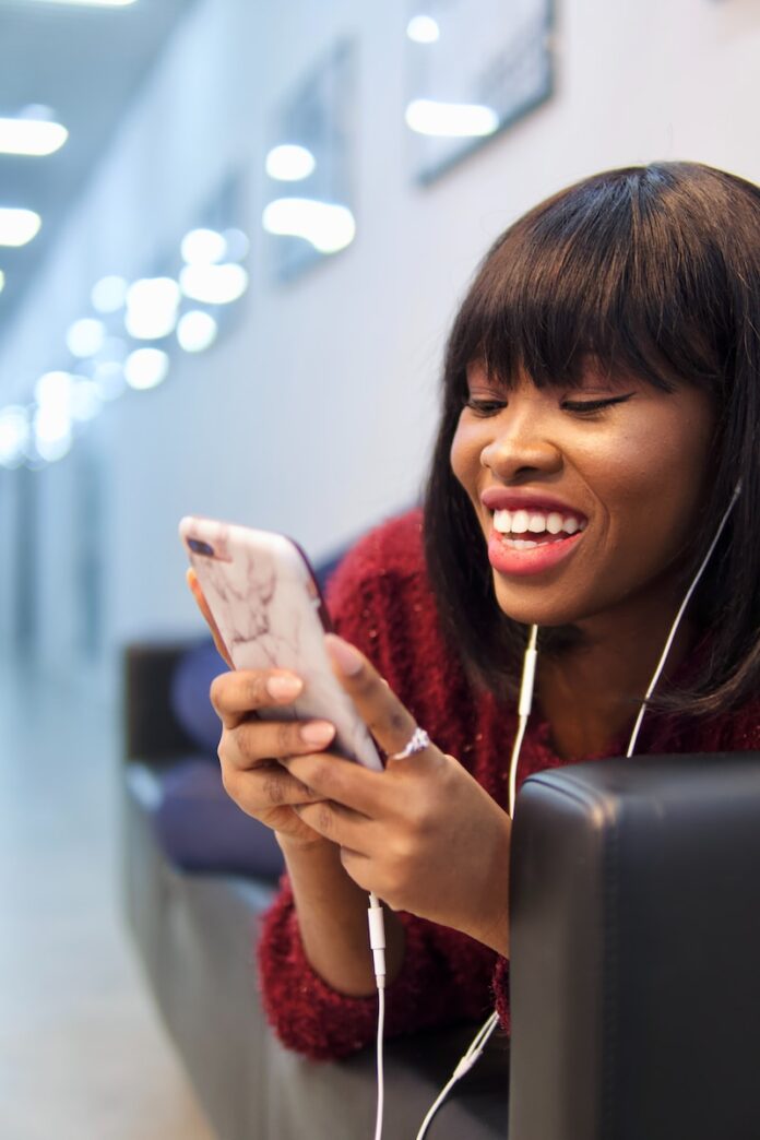 You Can Now Download Instagram Reels Posted By Others - Meta News woman in pink shirt holding white smartphone