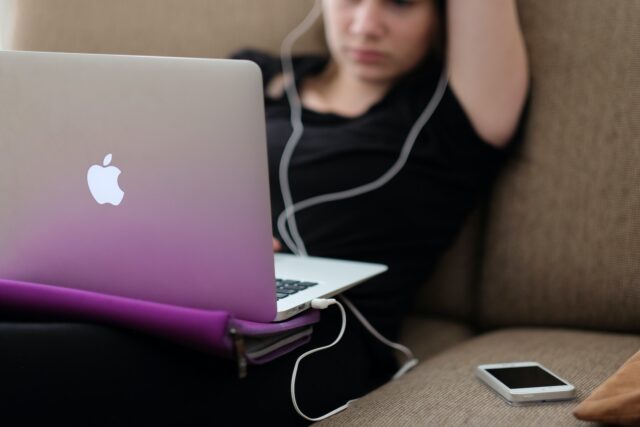 Photo by Steinar Engeland woman sitting on sofa with MacBook Air