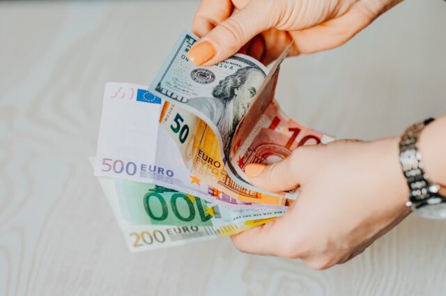 Photo by Omid Armin person holding 100 euro bill