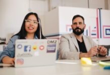 Boosting Employee Morale: How Engagement Platforms Make A Difference man and woman sitting side by side by the table