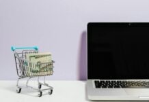 Crafting An Effective Marketing Strategy For Digital And E-Commerce Brands Shopping Cart Next to a Laptop