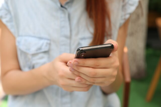 person holding using iPhone X