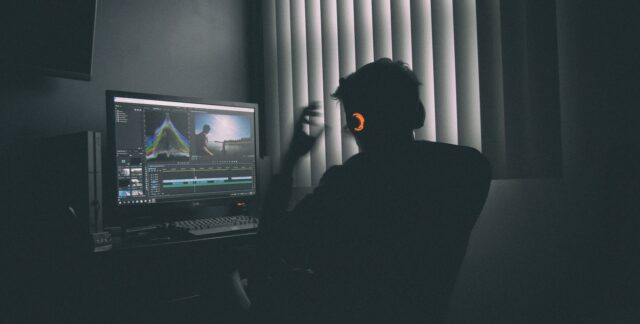 Photo by Mark Cruz shallow focus photography of man listing to music in front of the computer