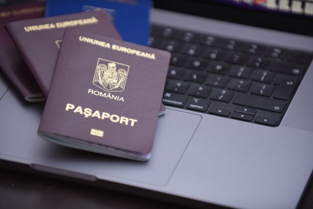 Romanian,Passports,Isolated,On,Gray,Laptop.,Bucharest,,Romania,2022 Romanian passport. Union Permits support in obtaining EU docs