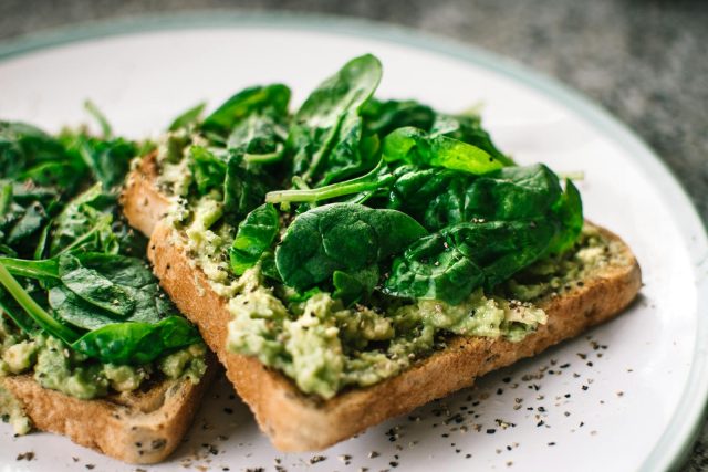 Photo by Lisa Fotios Close-up of a homemade avocado and spinach sandwich on whole grain toast.