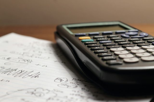 Photo by Aaron Lefler a calculator sitting on top of a piece of paper